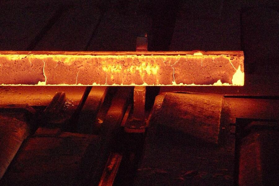 Glowing steel billet in a rolling mill