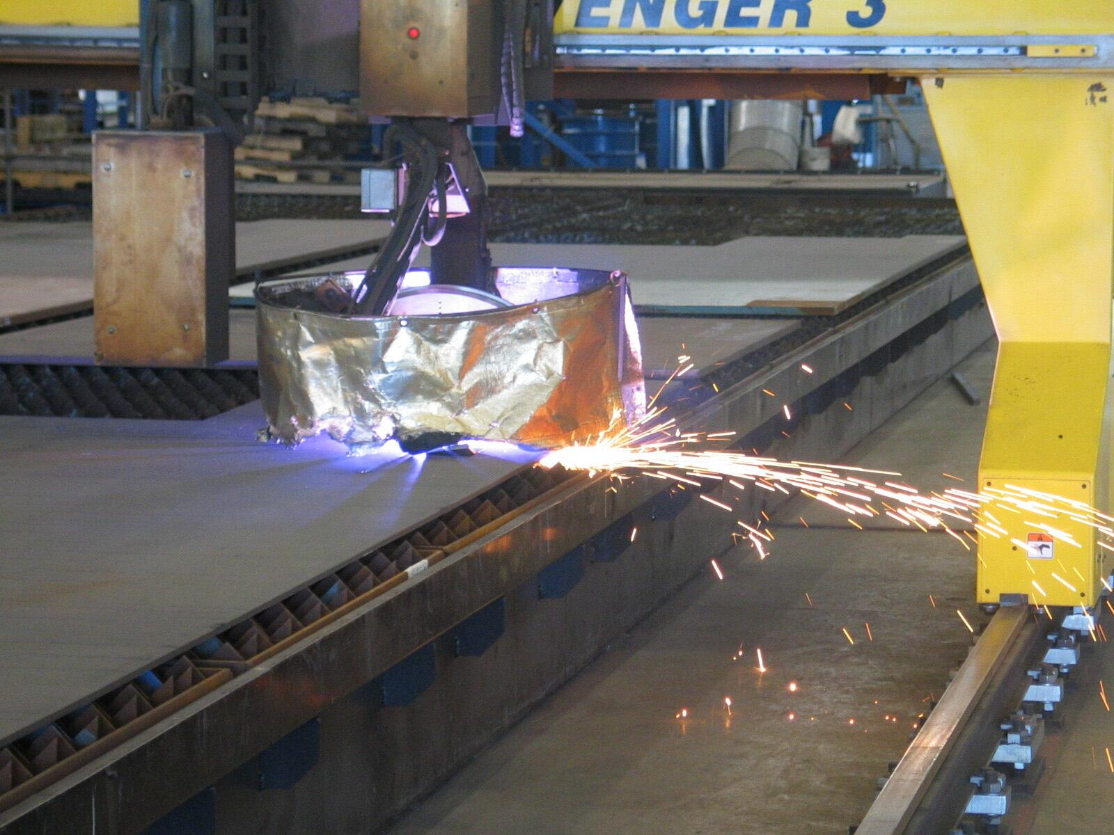 CNC plasma cutter slicing steel plate