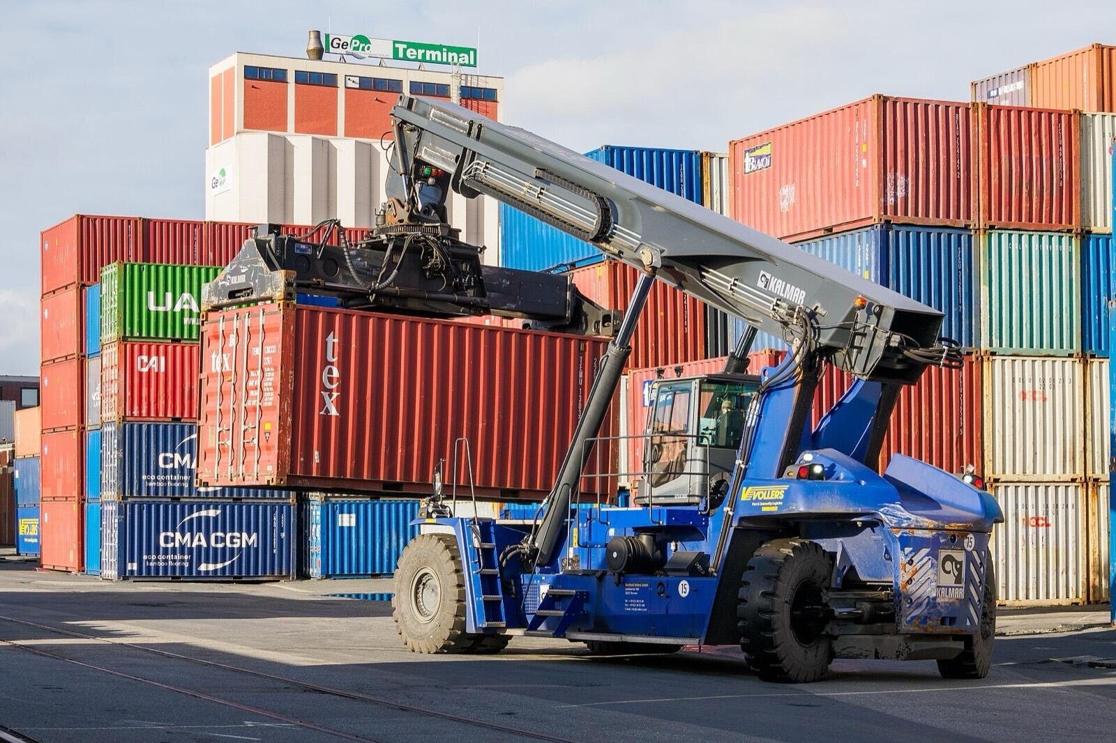 Reach stacker moving a container in the terminal yard